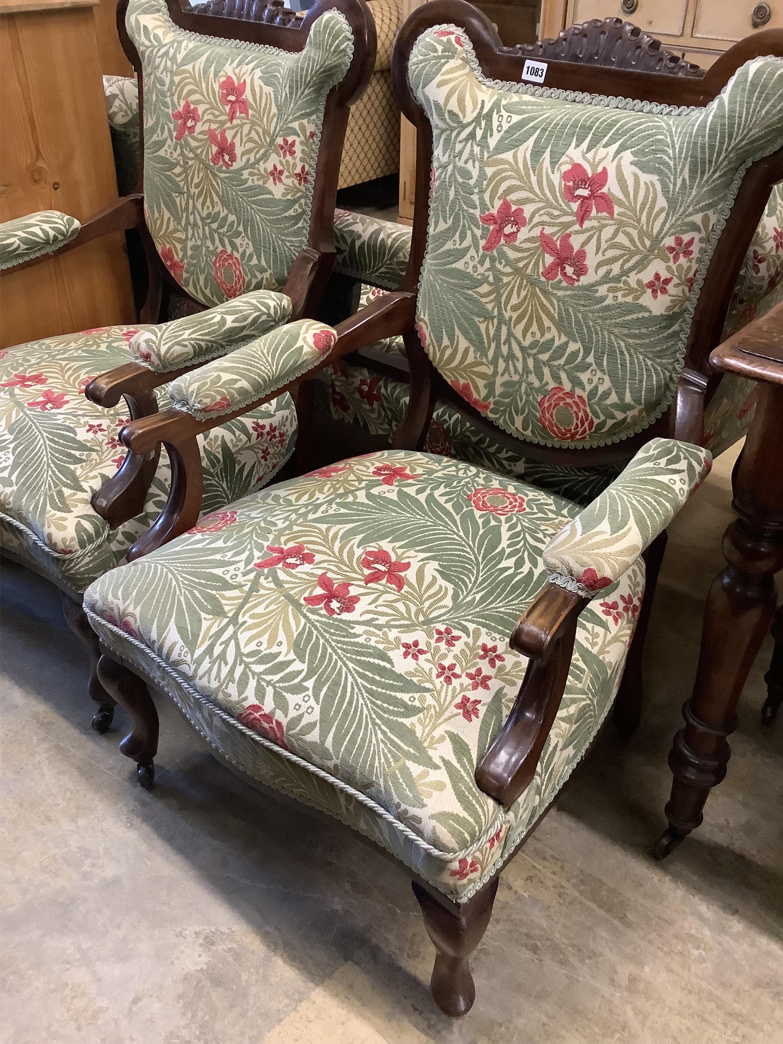 A pair of late Victorian mahogany upholstered armchairs